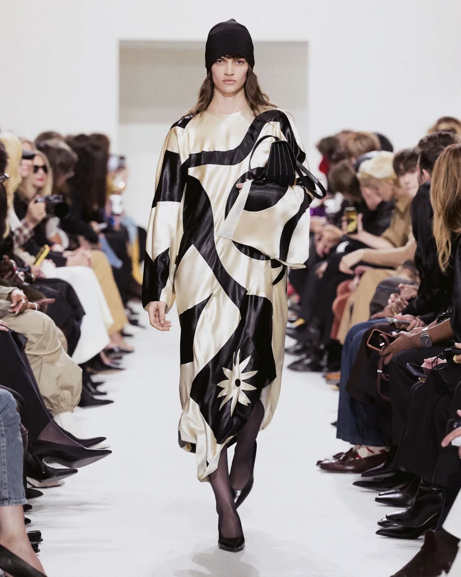 Celine Spring-Summer 2027 look in a black and ivory print with a black knitted hat on the runway